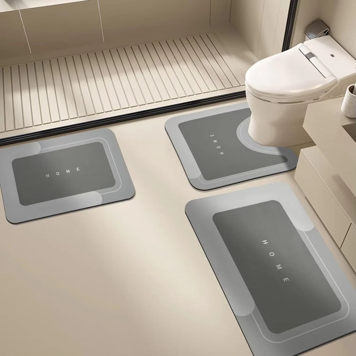 Three rectangular floor mats with the word HOME printed on them are placed in front of a white toilet.