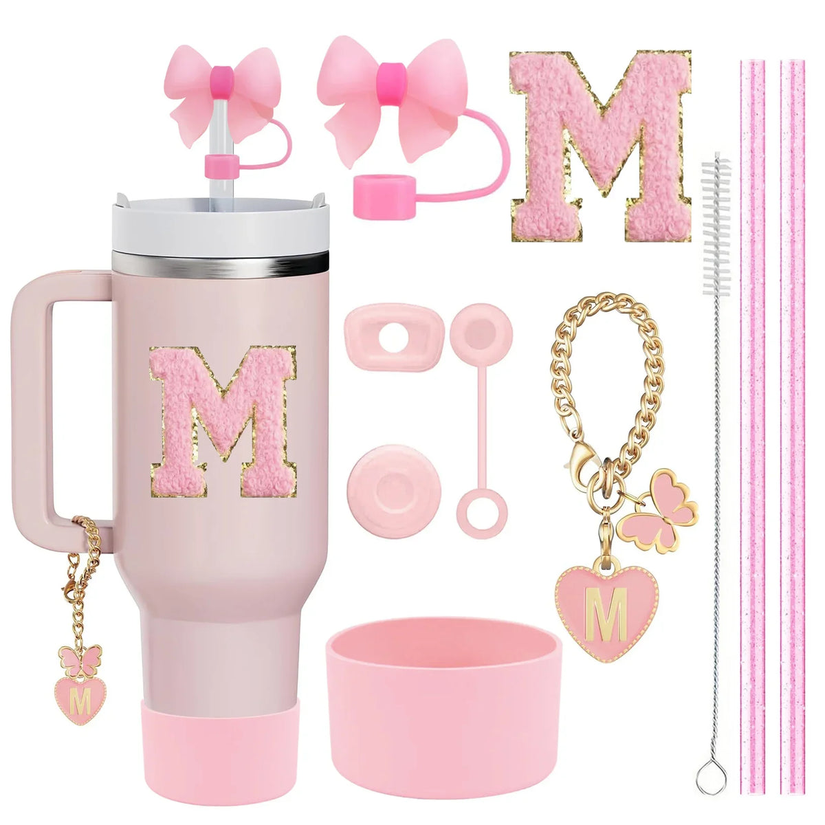 Pink Stanley cup accessory set featuring a pink tumbler, bow, letter M charm, brush, and gold necklace with a heart pendant.