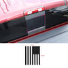 Black decorative trim cover for a vehicle's rear window, featuring an American flag design.