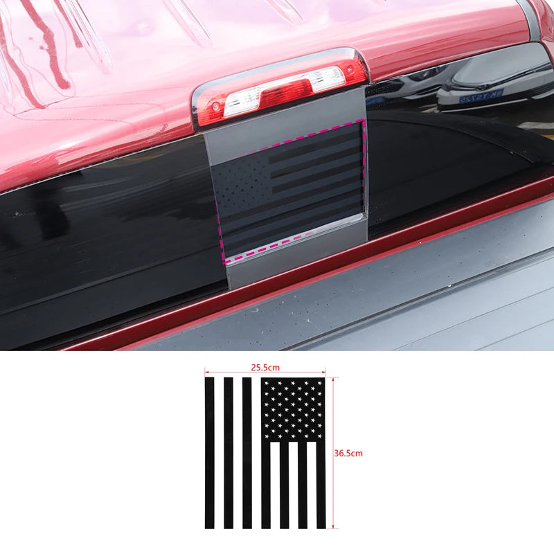 Black decorative trim cover for a vehicle's rear window, featuring an American flag design.