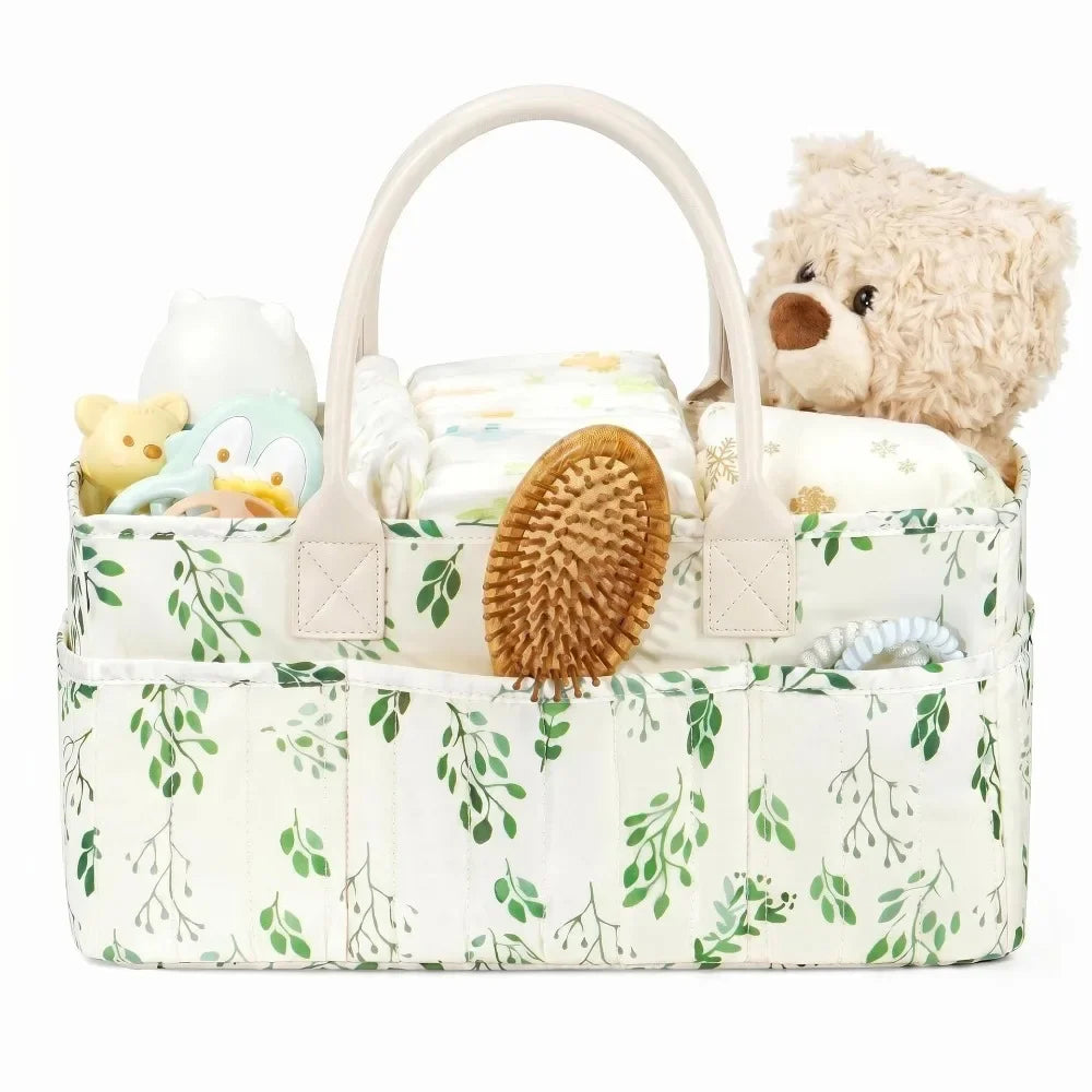 A cream-colored floral diaper organizer bag with multiple compartments, featuring a bear plush toy.
