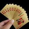 A hand holds a deck of luxury gold foil playing cards showing the Ace through King in red hearts.