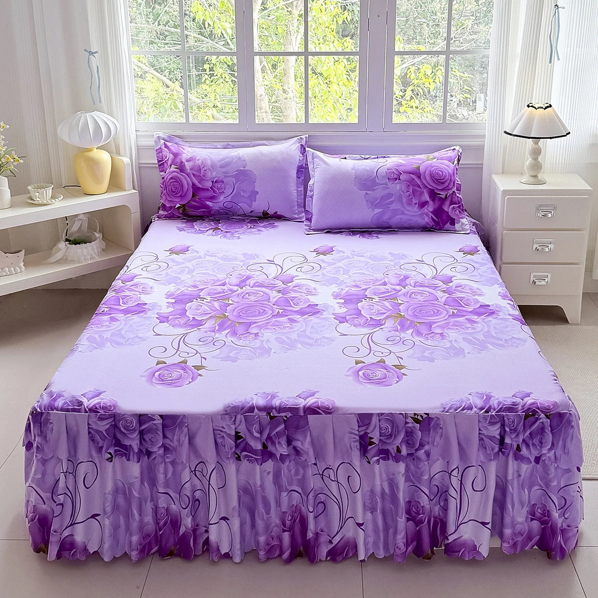 Purple floral print bed skirt and pillowcase set displayed on a bed with white bedding.
