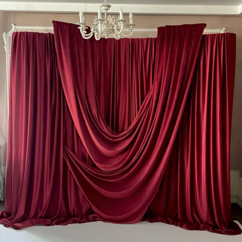 Elegant burgundy stretch jersey fabric draped as a backdrop or curtain.