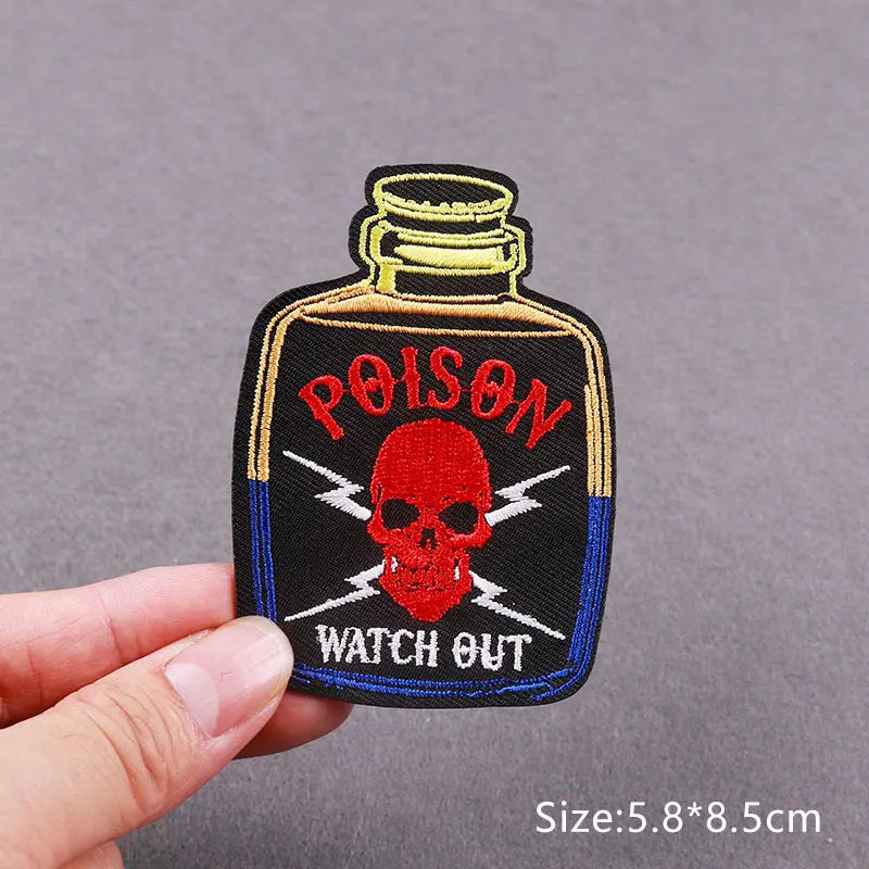 Black embroidered patch featuring a red skull and the text WATCH OUT OUT on a blue background