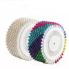 A collection of colorful round pearl straight pins in various shades including pink, green, purple, and white.