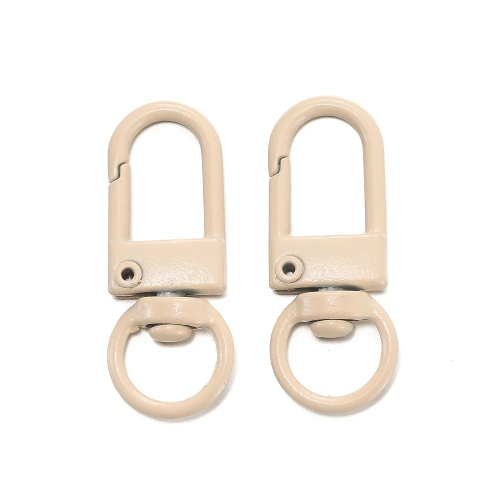 A pair of light beige alloy lobster clasp hooks for DIY jewelry making