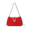 A vibrant red pleated evening clutch with a gold chain strap and a rhinestone closure.