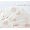 White waterproof shower cap with pink polka dots shown from above.