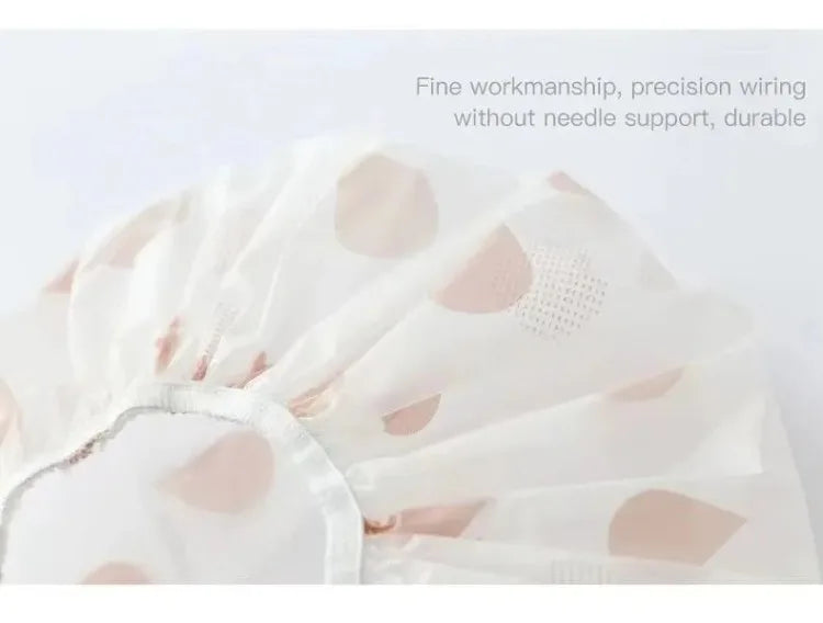 White waterproof shower cap with pink polka dots shown from above.
