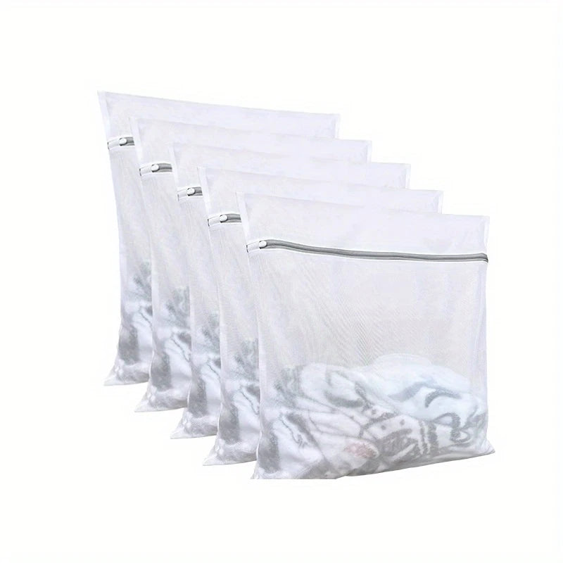 A row of clear mesh laundry bags stacked horizontally.