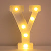 A glowing yellow LED letter night light shaped like the letter Y, illuminating various points.