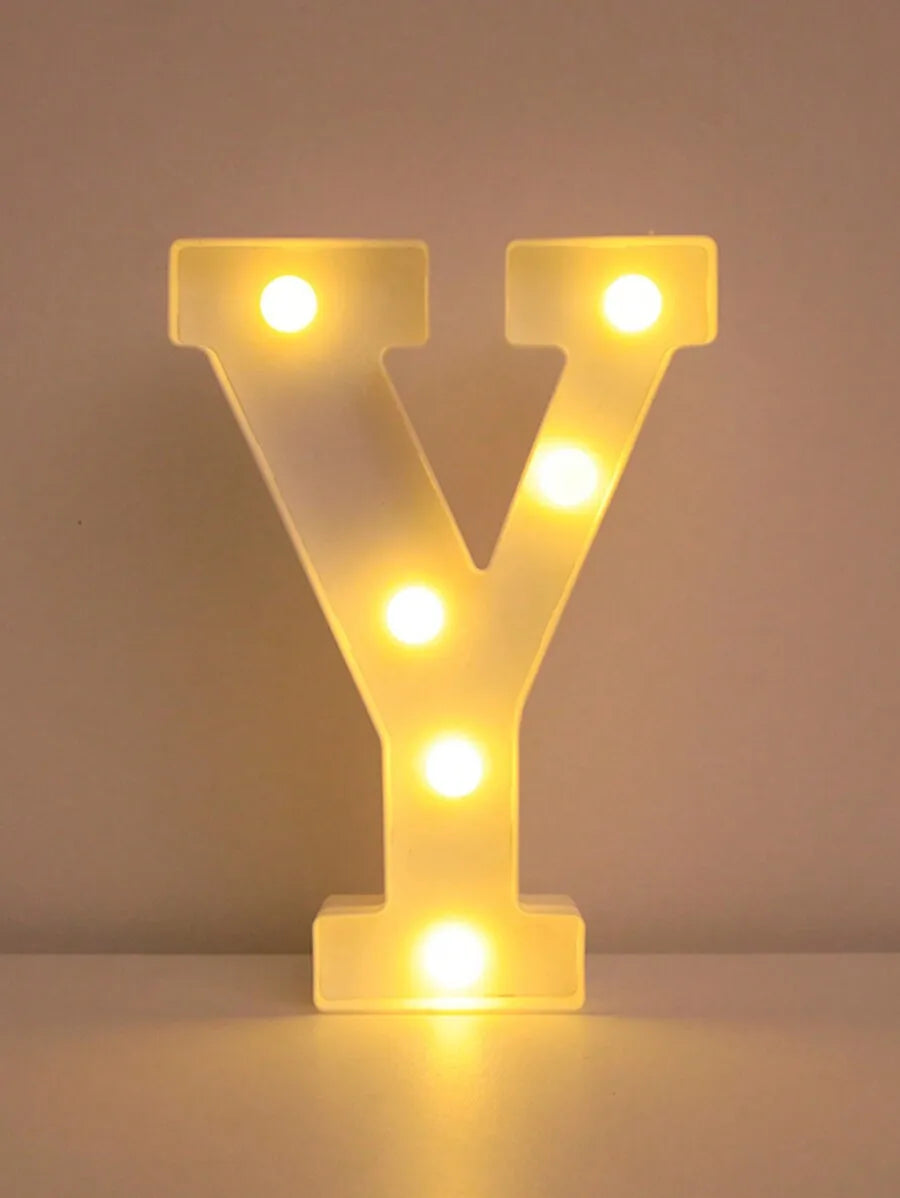 A glowing yellow LED letter night light shaped like the letter Y, illuminating various points.