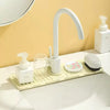 A white quick-dry faucet splash guard mat with a curved faucet and brush is displayed on a white countertop.