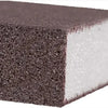 A rectangular block of dark gray Emery cleaning sponge with a white foam core.