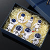 A collection of handcrafted astronaut figurine resin spacemen and a ring displayed in a dark blue box.