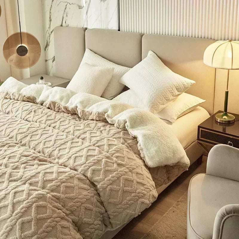 A beige luxury velvet duvet cover and blanket with white fluffy trim on a bed.