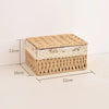 A rectangular handwoven rattan storage basket with a lid, made of natural beige fibers.