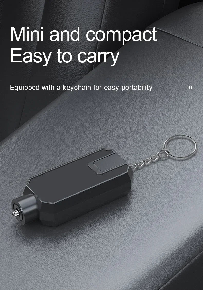 A black emergency car safety hammer with a keychain is shown resting on a dark gray surface.