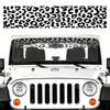 A white car's front windshield is covered with a black leopard print sunshade decal strip.