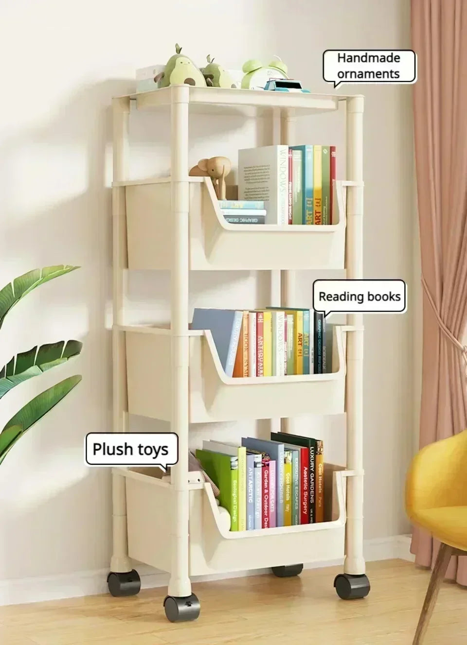 A white mobile multi-tier storage cart with wheels displaying handmade ornaments, reading books, and plush toys.