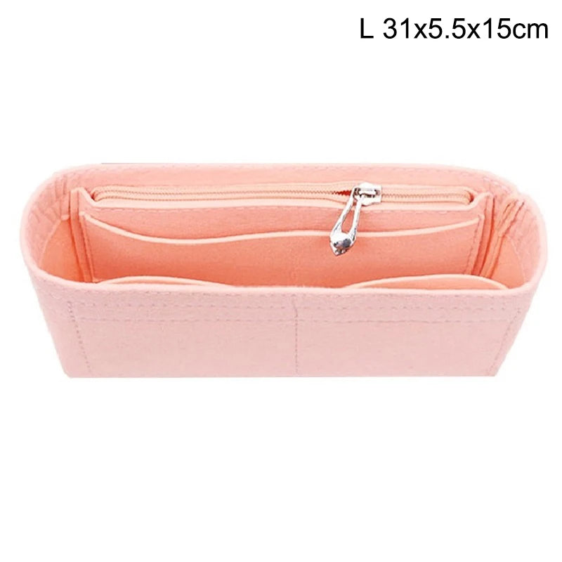 A pink felt bag organizer with multiple internal pockets and a silver clasp.