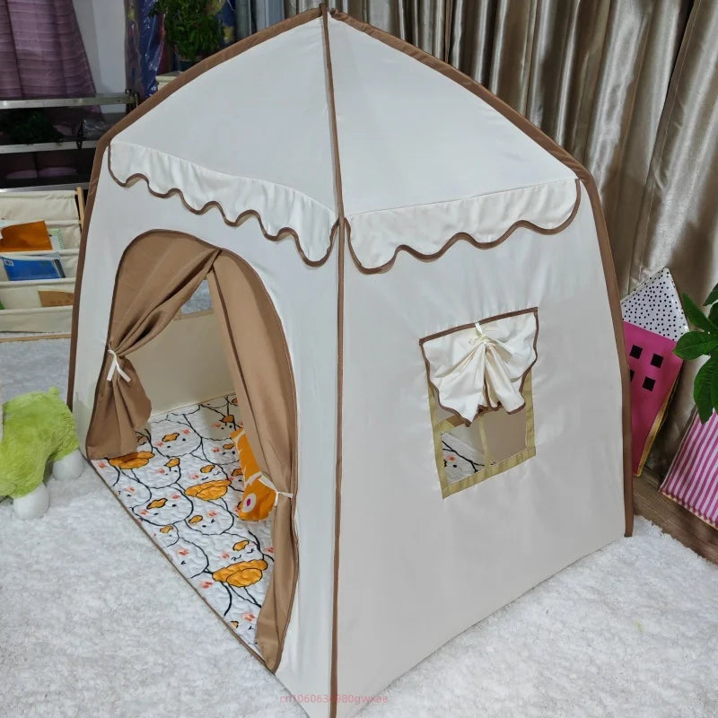 A white foldable kids teepee play tent with brown fabric and ventilation windows set up indoors.
