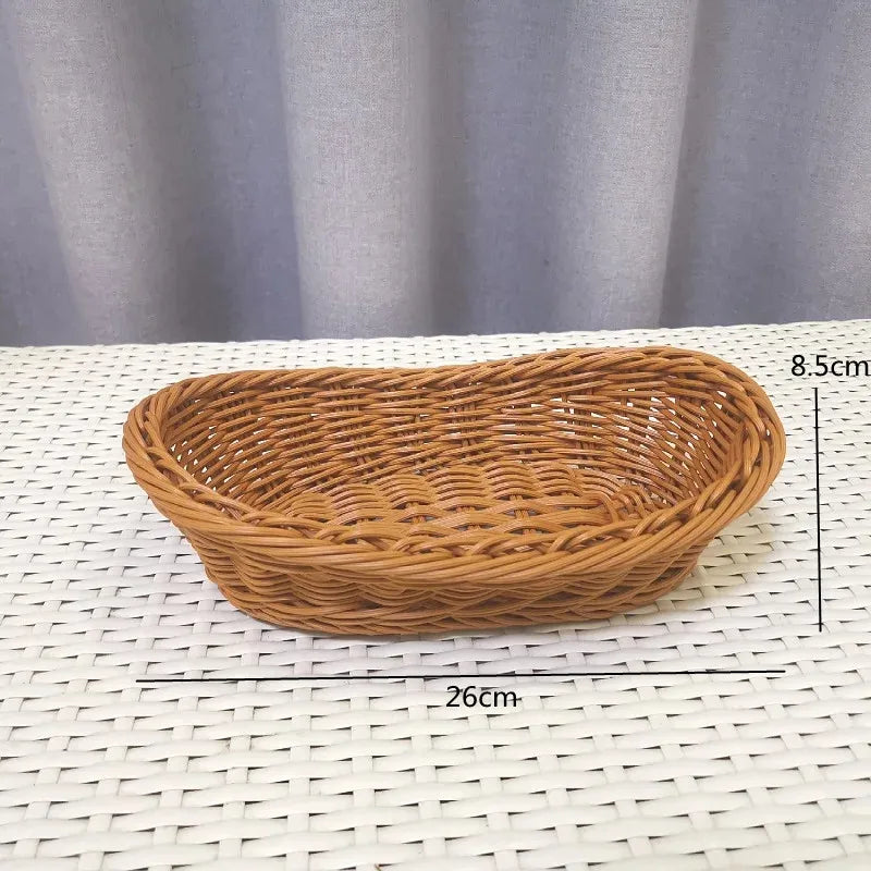 Handwoven wicker serving basket with a natural brown color displayed on a white surface.