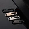 A set of eight metal zipper sliders in various finishes, including black and brass tones, displayed against a dark background
