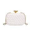 A white handwoven woven clutch bag with a gold chain strap is shown against a white background.