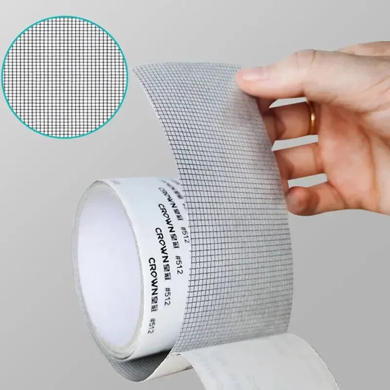 A hand is applying a self-adhesive fiberglass screen repair patch to a surface, showing the texture of the mesh material.