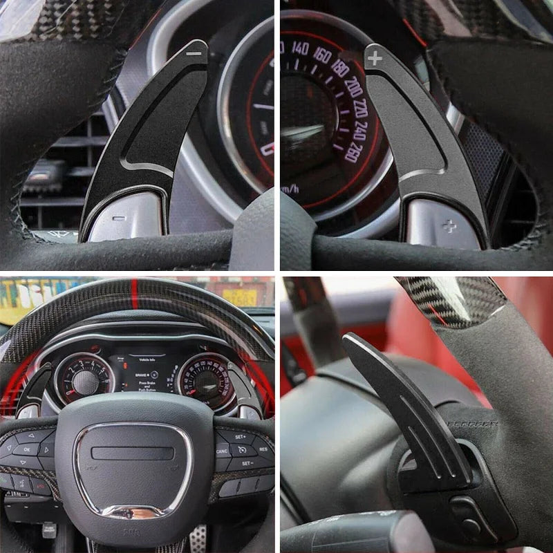 Close-up view of a steering wheel with red anodized aluminum shift paddle extenders and controls.