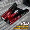 A roll of deep metallic red car window tint film displayed on a gray textured surface.