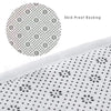 Close-up view of a white skid-proof backing material with a repeating pattern of small black dots.