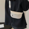 A black blazer features a cream-colored multi-pocket PU leather waist bag with an adjustable strap attached to the shoulder.