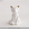 White ceramic elephant and rabbit jewelry holder with gold accents, sitting on a white surface.
