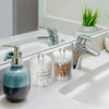 Clear apothecary jar storage set with lids for vanity and bathroom organization featuring glass bottles and metal spigots