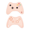 A pink silicone baby teether toy shaped like a remote control, featuring various letter and number buttons.