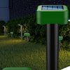 A green solar-powered ultrasonic snake repellent device is shown standing upright in a garden setting.
