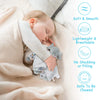 A baby is sleeping peacefully while holding a soft gray elephant plush toy and wearing a light-colored blanket.