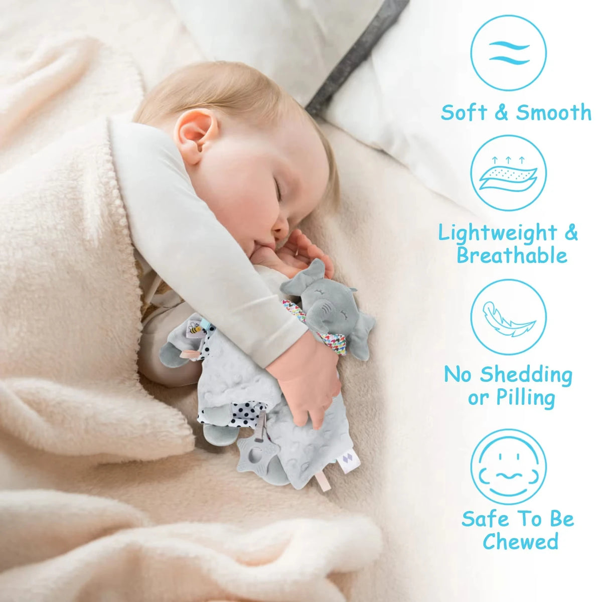 A baby is sleeping peacefully while holding a soft gray elephant plush toy and wearing a light-colored blanket.
