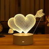 A glowing white heart shape made of wire mesh is displayed on a round base, functioning as an LED night light.