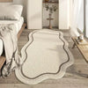 A light beige irregular area rug with subtle gray edging placed on a wooden floor.