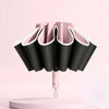 A pink fully automatic reverse-folding windproof umbrella with UV protection displayed against a light pink background.