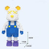 A white and yellow mini angry bear building block set with blue overalls and purple feet.