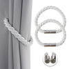 Two white rope magnetic curtain tiebacks with silver clasp components shown next to a gray curtain.