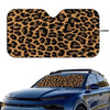 Leopard print car windshield sunshade applied to a blue car window.