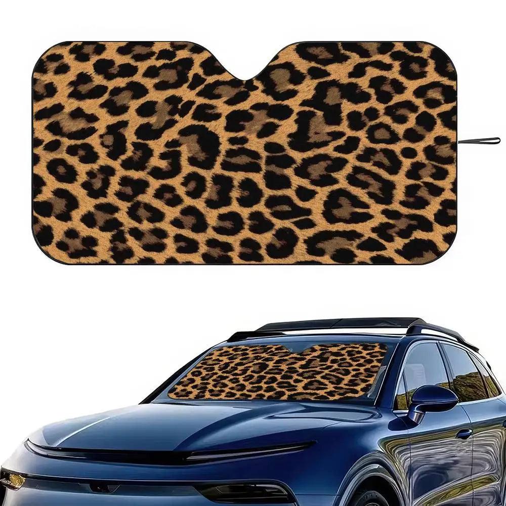 Leopard print car windshield sunshade applied to a blue car window.