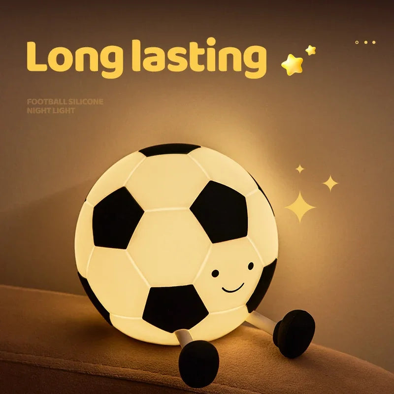 A glowing soccer ball night light with a touch control feature resting on a surface.