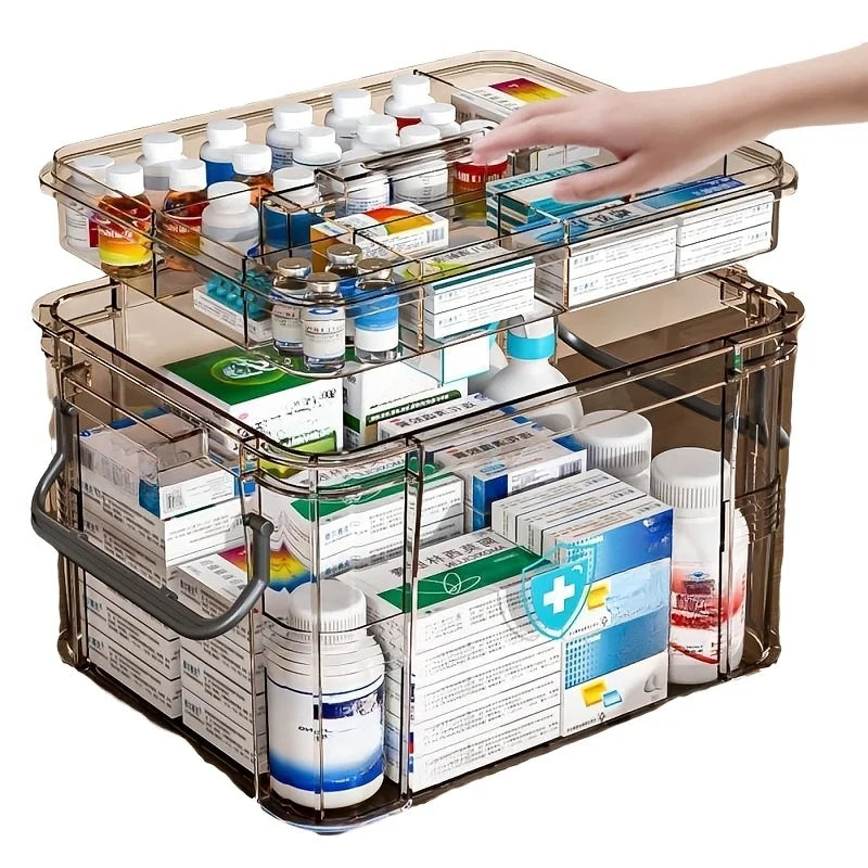 A transparent plastic first aid storage box with a handle, filled with various medical supplies and bottles.